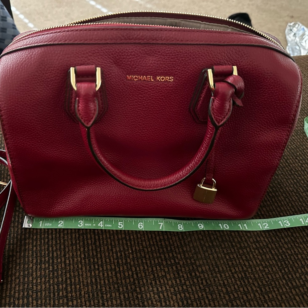 Red leather Michael Kors handbag. Comes with shoulder strap and dust bag.